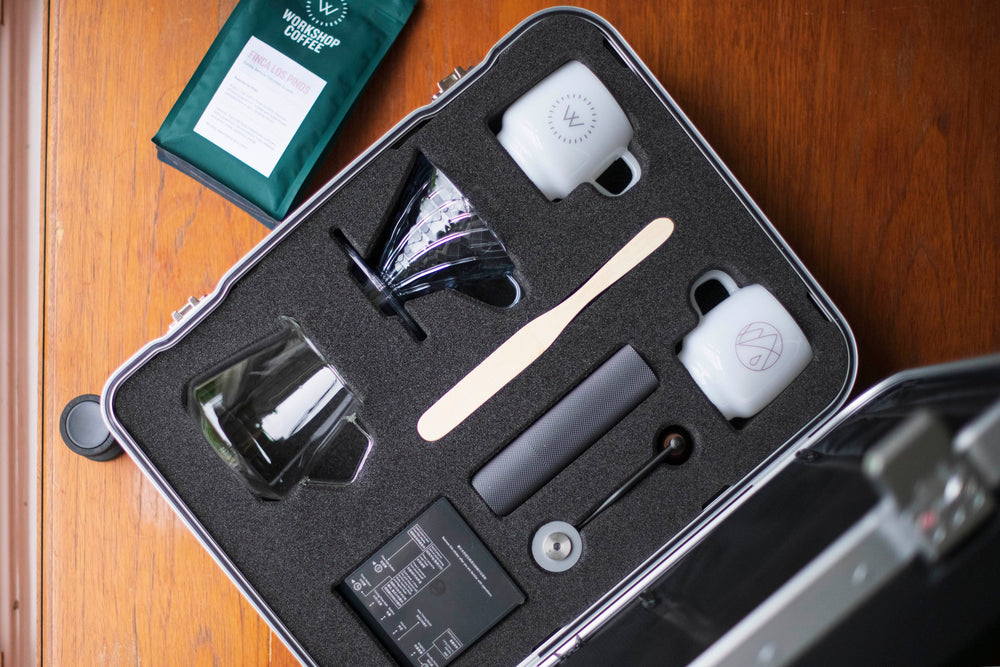 Open luxury suitcase with laser cut coffee accessories compartment with Workshop Coffee filter bag